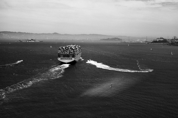 Container ship with pilot boat approaching